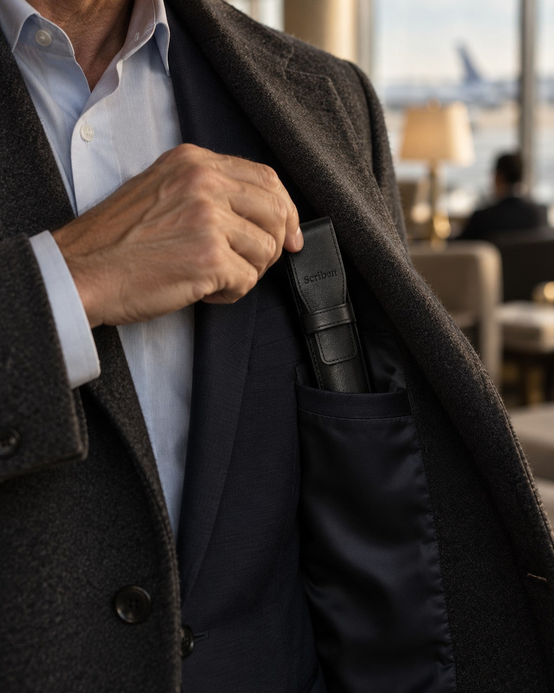Scriben leather pen case slipped into a suit jacket's inner pocket