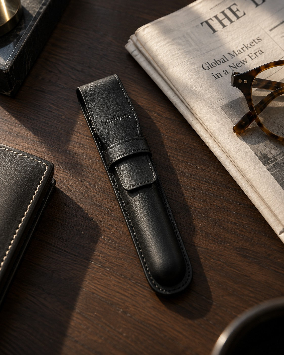 Scriben genuine black leather pen case on a walnut desk